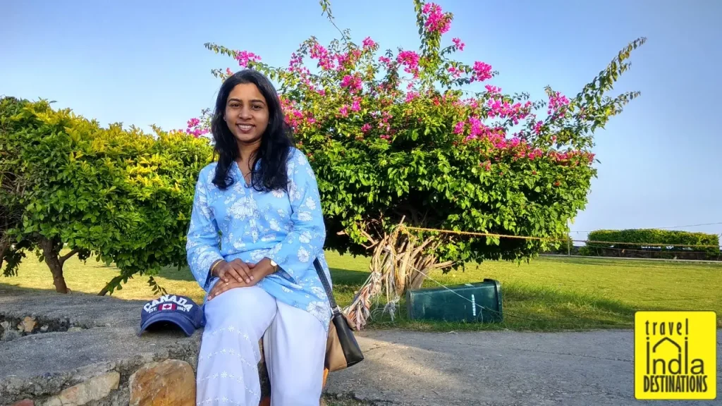 A woman posing in the garden area at Sajjangarh Monsoon Palace in Udaipur.