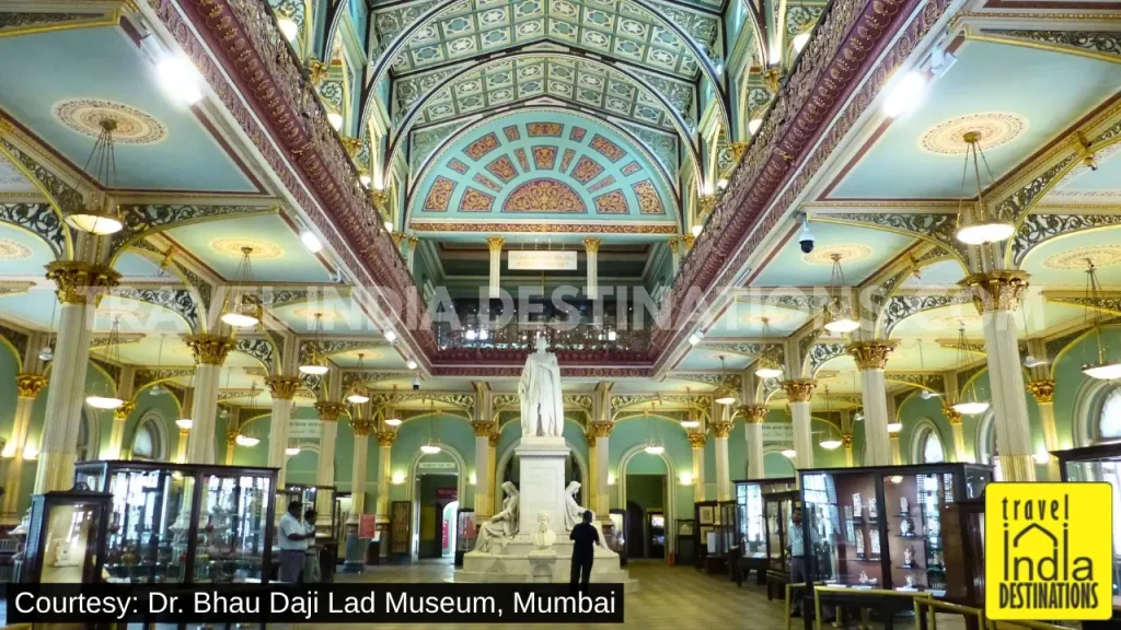 Main hall of Dr. Bhau Daji Lad Museum with glass display cabinets and statues