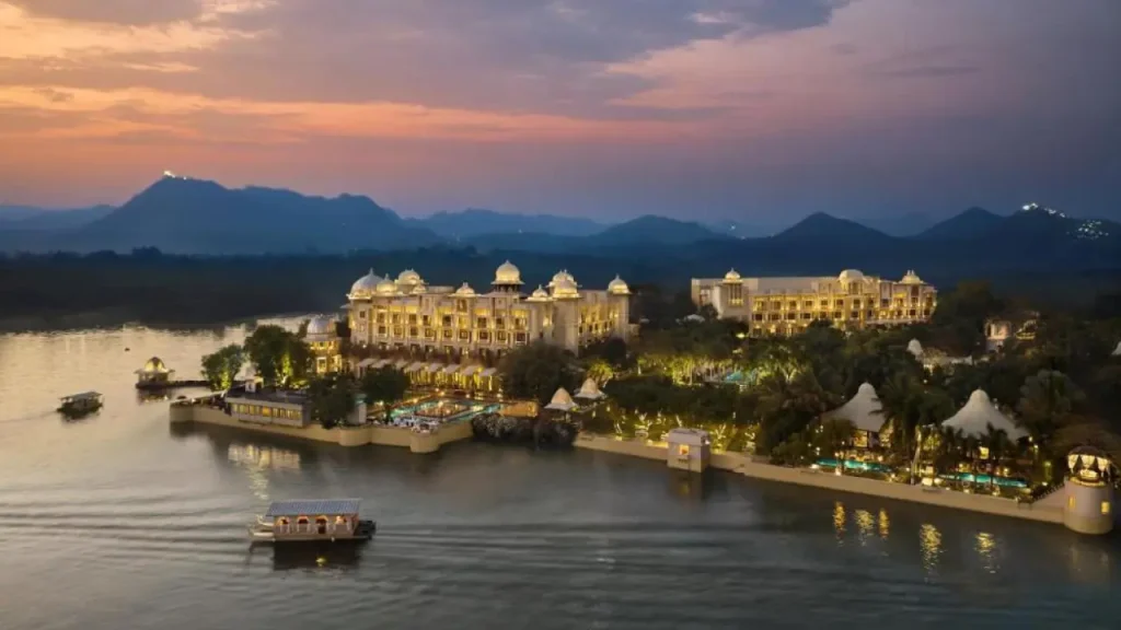 An overview shot of The Leela Palace with the surrounding Aravali hills in the background, one of the best lake view hotels in Udaipur.