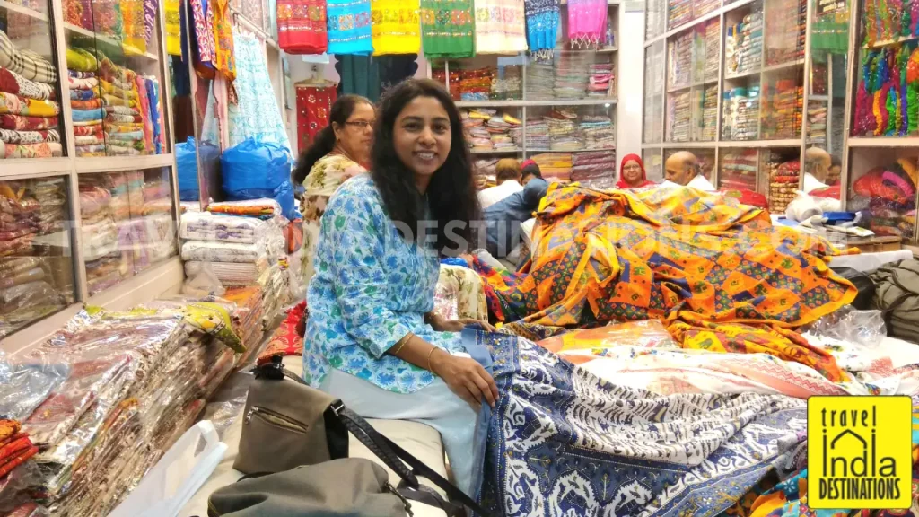 A woman shopping bedsheets at one of the local stores in the markets of Udaipur.