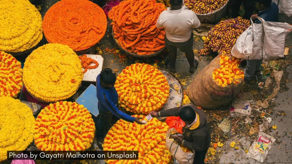 Shoppers buying marigold flowers at Gandhi Bazaar in Bangalore, one of the best markets for Diwali shopping.