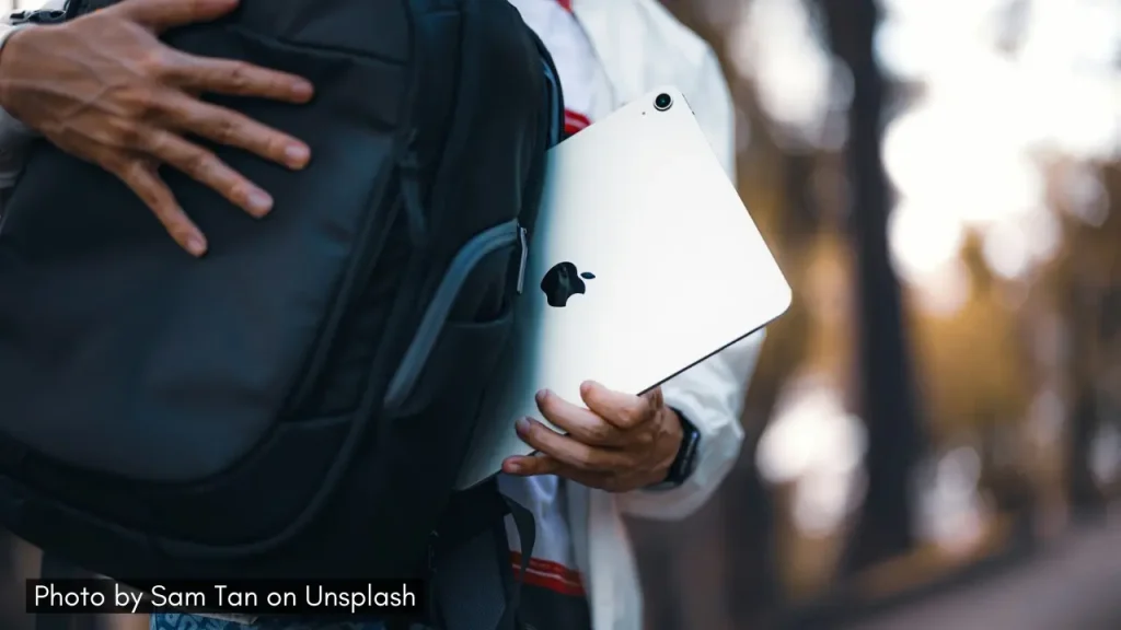 A shot of a person placing a laptop inside a laptop bag.