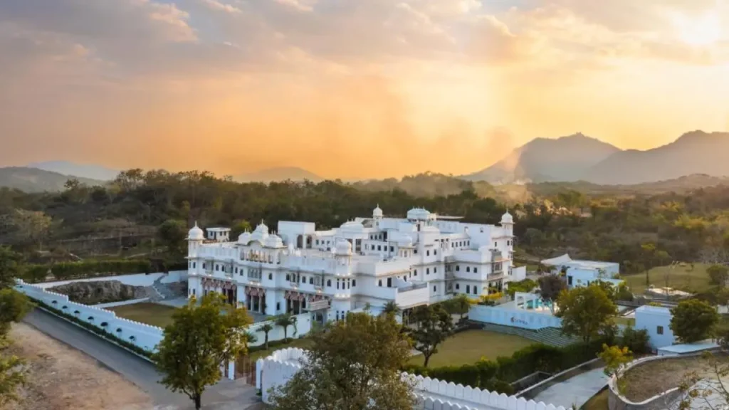 An overview of the Lebua Daulatgarh showcasing heritage property and surrounding hills in Udaipur.