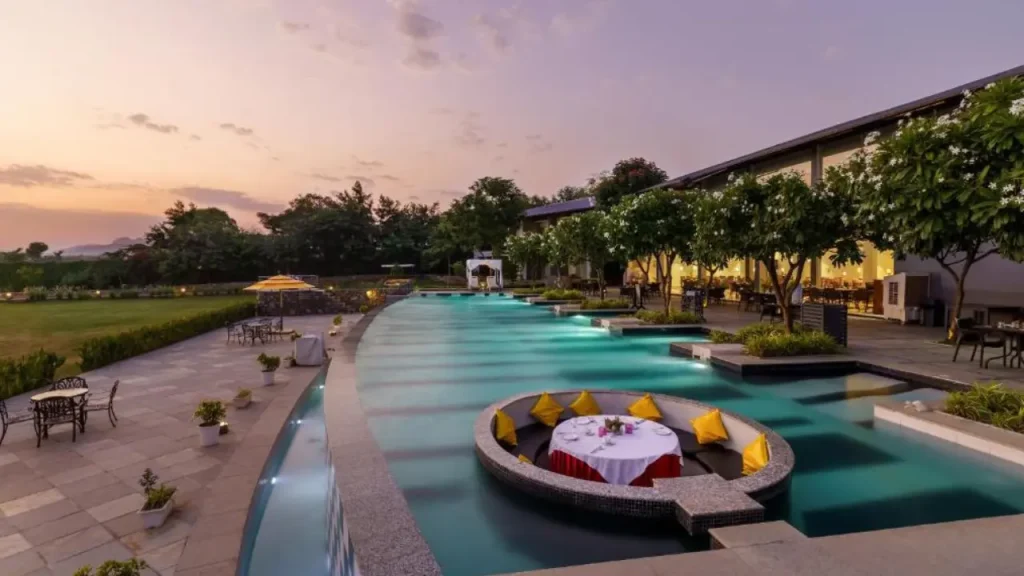 A picture of outdoor swimming pool at TatSaraasa Resort & Spa, one of the best hotels in Udaipur for couples.